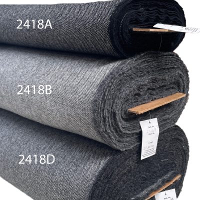 Irish tweed fabric in classic herringbone patterns. Swatch shows natural white warp with black, mid grey and charcoal wefts.