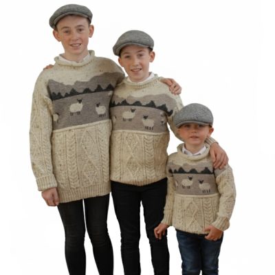 Kids wool sweater knit with aran stitches and sheep landscape with the Macgillycuddy Reeks in the backround. Fun to wear